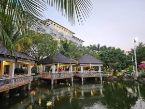 a building next to a body of water at Spring Garden Hotel in Long Khanh