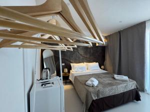 a small bedroom with a bed and a refrigerator at Bella Gallery Terrasini in Terrasini