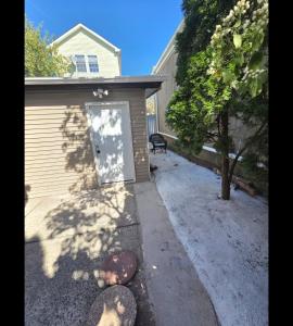 a garage with a door in the side of a house at Newly built Studio Close to NYC and EWR in Irvington