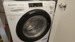 a white washing machine sitting next to a washer at Sfazion - Central Apartment in Bari