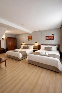 a hotel room with three beds in it at Hotel Aris in Sofia +39 photos