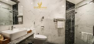 a bathroom with a white toilet and a sink at Spring Garden Hotel in Long Khanh +14 photos