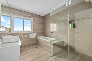 a bathroom with a toilet and a glass shower at Charming 5-Bedroom House in Harrison