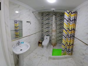 a bathroom with a sink and a toilet at Safo Hotel Turkestan in Türkistan