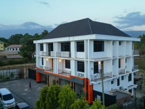 a white building with a black roof at Kili Tanzania in Moshi
