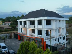 a white building with a black roof at Kili Tanzania in Moshi