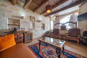 a living room with a couch and a table at Divan Cave House in Göreme