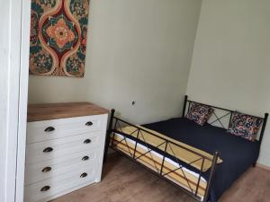 a bedroom with a bunk bed and a dresser at Sunny side apartman in Sopron
