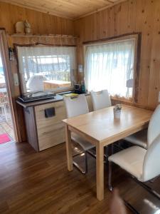 a kitchen with a table and chairs in a room at Zillerstadl - 5 Sterne Erlebnisresort Aufenfeld, Aschau in Aschau