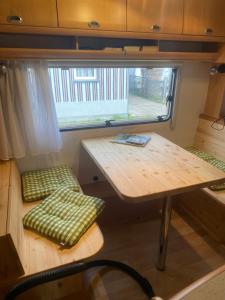 a small room with a table and a bench at Zillerstadl - 5 Sterne Erlebnisresort Aufenfeld, Aschau in Aschau +2 photos