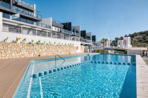 a swimming pool on the side of a building at Stunning House, 3BR, HOT TUB, WIFI, Parking in Finestrat