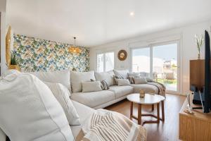 a living room with a white couch and a table at Stunning House, 3BR, HOT TUB, WIFI, Parking in Finestrat
