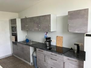 a kitchen with stainless steel cabinets and a counter top at Nr 6 Camping Pod mit Terrasse und Seeblick in Langenbernsdorf