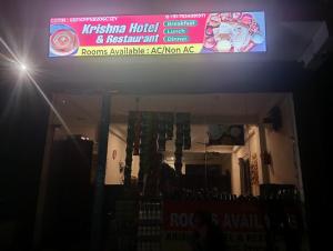 a sign on the front of a restaurant at Krishna Hotel & Restaurant in Devaprayāg