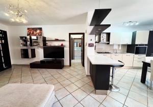 a kitchen with white cabinets and a black counter top at Oasi della pace in La Maddalena