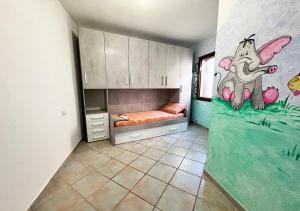 a room with a bed and a mural of an elephant at Oasi della pace in La Maddalena