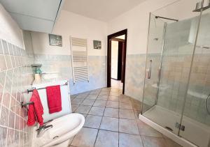 a bathroom with a toilet and a glass shower at Oasi della pace in La Maddalena +18 photos