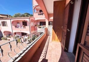 a balcony of a building with a view of a city at Oasi della pace in La Maddalena