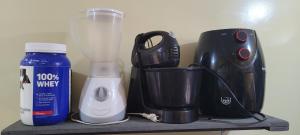 a counter with a blender and other appliances on it at Joy Hostel in Salvador