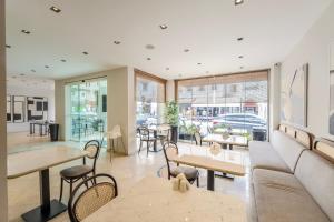 a restaurant with tables and chairs and a couch at Casa Alloro Bodrum in Bodrum City
