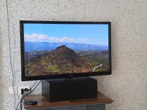 a flat screen tv sitting on top of a table at hotel for decent people in Tashkent
