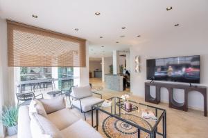 a living room with a couch and a tv at Casa Alloro Bodrum in Bodrum City