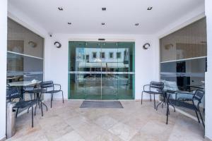 a room with tables and chairs and a glass door at Casa Alloro Bodrum in Bodrum City