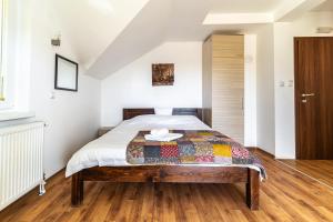 a bedroom with a bed with a quilt on it at Hestia Apartments in Berovo