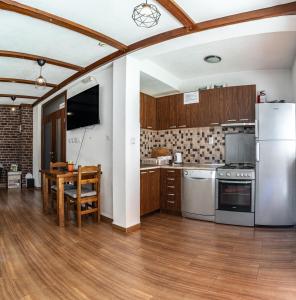 a kitchen with a table and a refrigerator at Hestia Apartments in Berovo