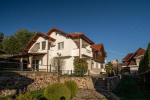 a white house with a brown roof at Hestia Apartments in Berovo