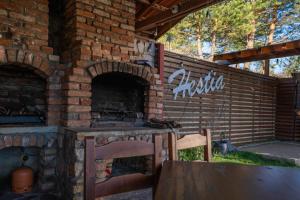 a brick oven with a table and chairs in it at Hestia Apartments in Berovo