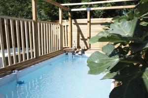 a swimming pool with a pergola and a table and chairs at Garden Spa in Caudebec-lès-Elbeuf