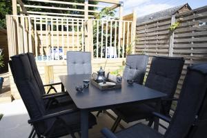 a black table and chairs on a patio at Garden Spa in Caudebec-lès-Elbeuf