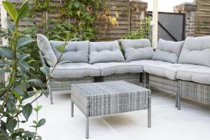 a patio with a couch and a table at Garden Spa in Caudebec-lès-Elbeuf