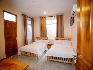 a room with two beds and a window at Kili Tanzania in Moshi +24 photos