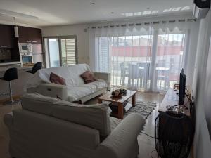 a living room with a couch and a table at Quarportugal in São Martinho do Porto