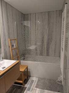 a bathroom with a tub and a sink and a shower at Quarportugal in São Martinho do Porto +25 photos