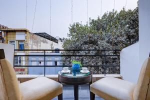 a balcony with two chairs and a table with a view at Hotel The Metropolis Tourist Near Connaught Place And Ramakrishna Ashram Marg Metro Station in New Delhi