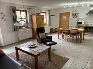 a living room with a table and a dining room at Ferienwohnung Ott in Weißenburg in Bayern