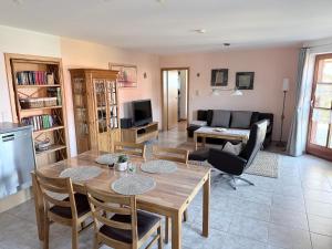 a living room with a table and chairs and a couch at Ferienwohnung Ott in Weißenburg in Bayern
