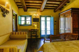 a room with a bed and a couch and a table at Il Poggio di Teo in Manciano +81 photos