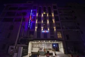 a building with a blue and white sign on it at Avari Xpress Faisalabad in Faisalabad