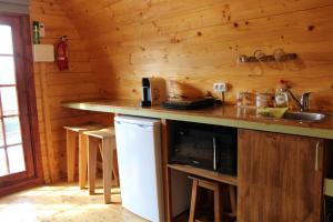 a kitchen in a log cabin with a counter at Quinta Da Devesa B1 in Vinhais
