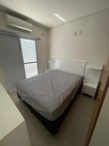 a bedroom with a large bed and a window at Apartamento in Socorro