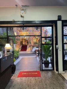 an open door to a building with a plant in theoyer at Milan Hotel & Restaurant in Phnom Penh