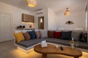 a living room with a couch and a table at Aqua Cozy Suites in Perissa