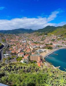 an aerial view of a town next to a beach at Casa Vanda, Machico in Machico
