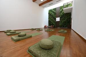 a room with several meditation mats on a wooden floor at The Imperial, New Delhi in New Delhi