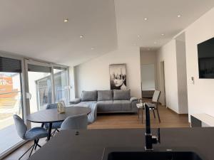 a living room with a couch and a table at Apartment Lasta Medulin in Medulin