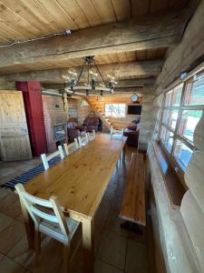 a dining room with a long wooden table and chairs at Oksa Puhkemaja in Võru
